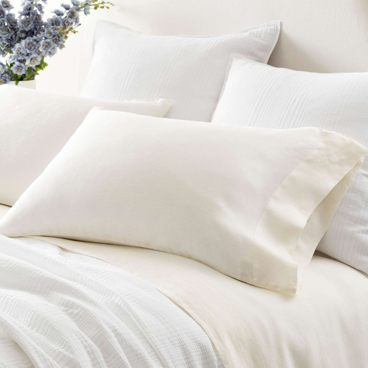 Lush Linen Ivory Pillowcases styled with white bedding. Styled view.
