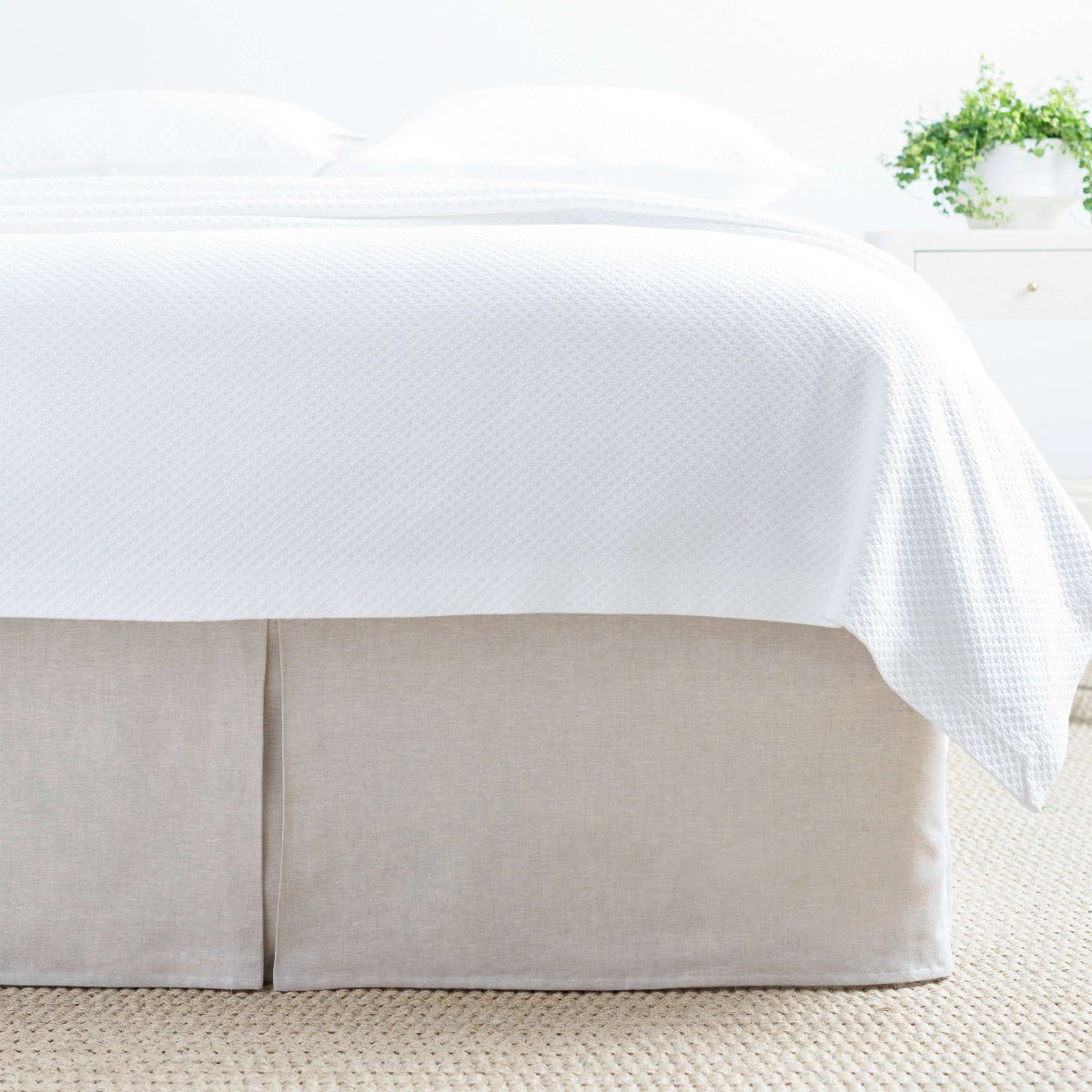 Lush Linen Natural Bed Skirt styled with white bedding. Styled view. 