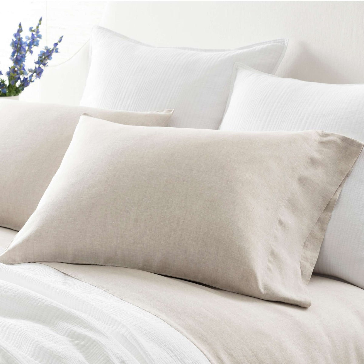 Lush Linen Natural Pillowcases styled with white bedding. Styled view.