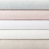 Stack of lush linen duvet covers. Styled view.