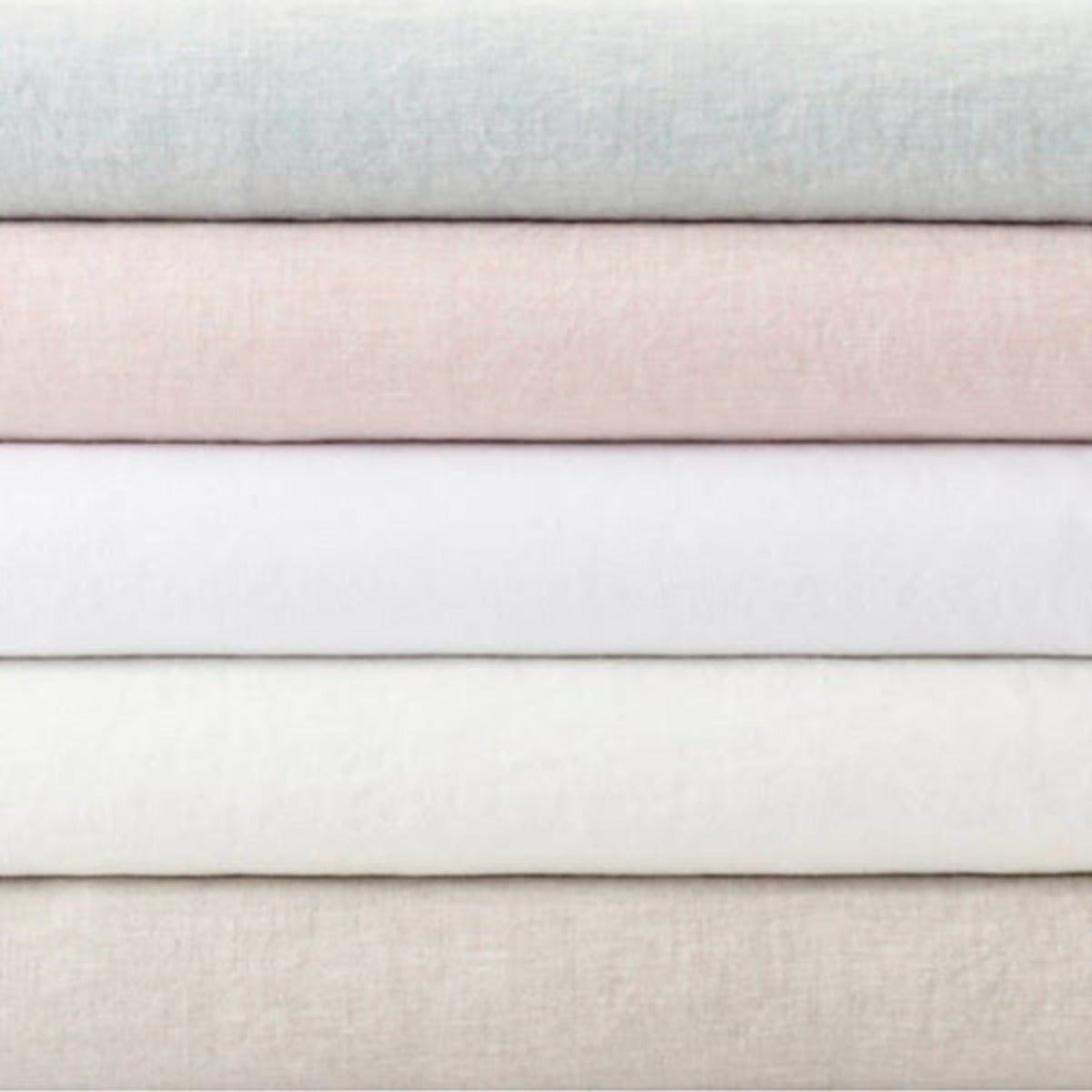 Stack of lush linen duvet covers. Styled view.