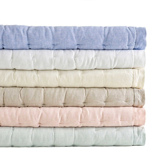 Folded stack of puffs in a variety of colours. Styled view.