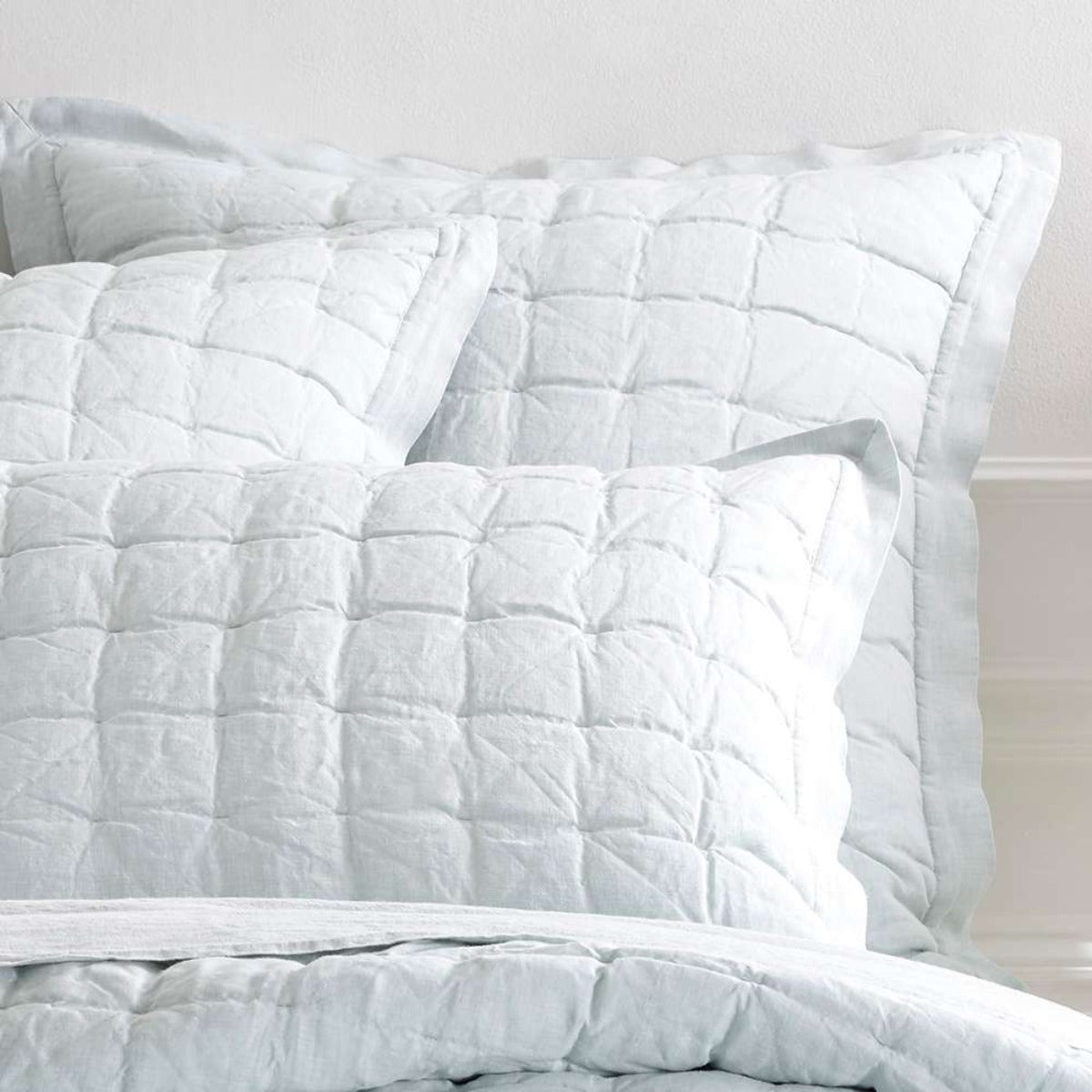Lush Linen Sky Puff Sham styled with light sheets. Styled view. 