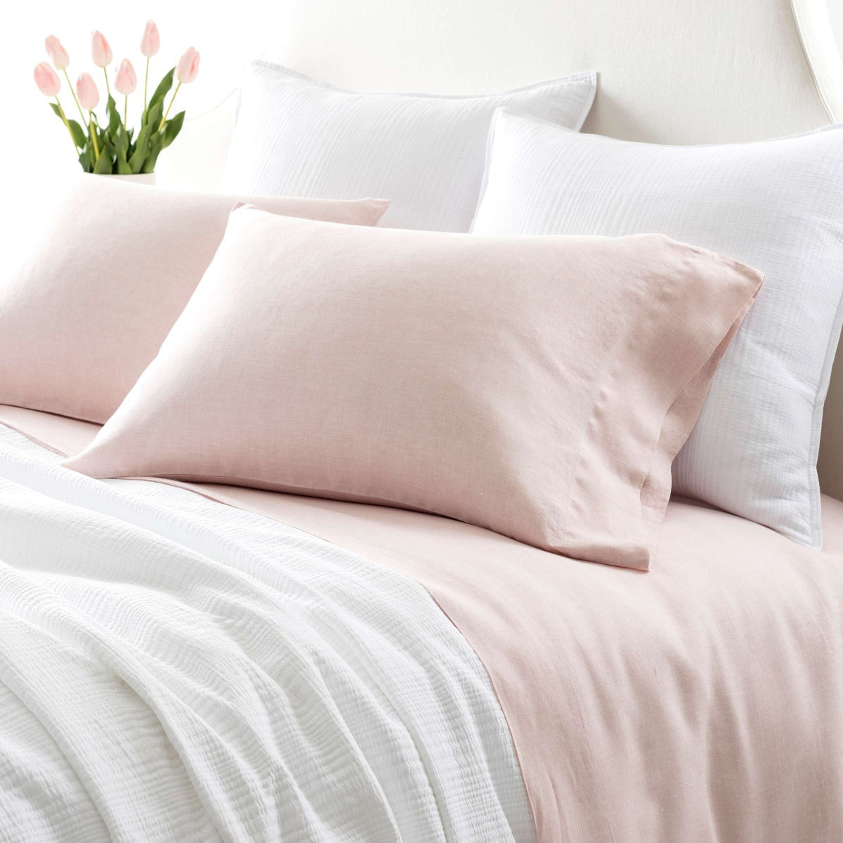 Lush Linen Slipper Pink Sheet Set styled with white bedding. Styled view. 