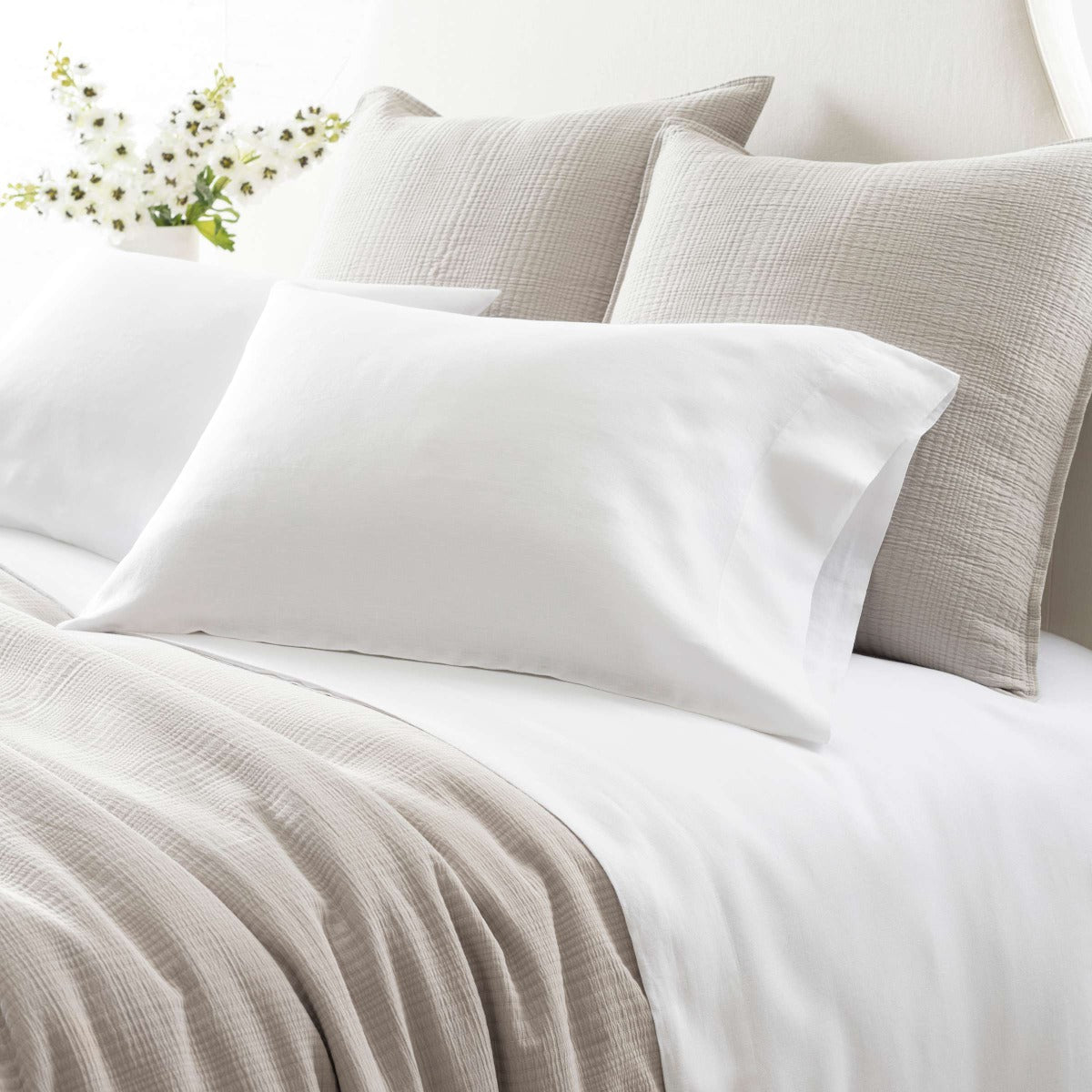 Lush Linen White Sheet Set styled with grey bedding. Styled view. 
