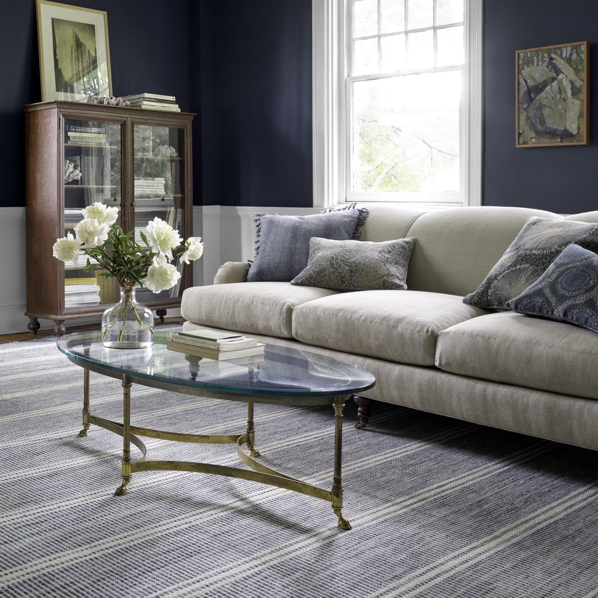 Malta Blue Woven Wool Rug styled in a blue living room. Styled view. 