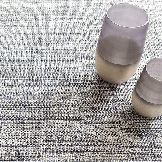 Marled Indigo Woven Cotton Rug styled under decor. Styled view. 