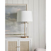 Magelian Glass Table Lamp styled on a white table with artwork. Styled view.