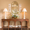 Nottingham Alabaster Table Lamp styled on a wood console table with greenery. Styled view.