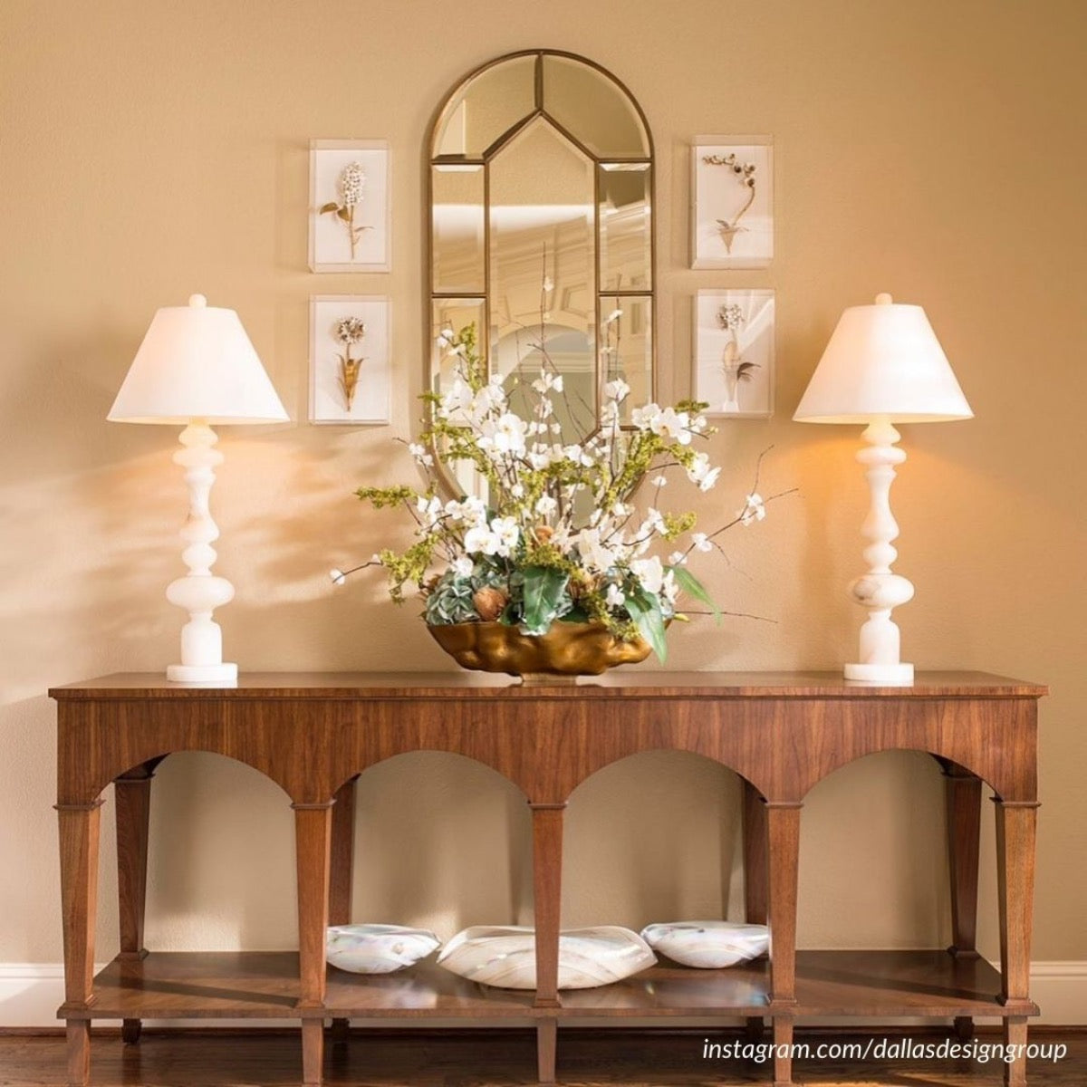 Nottingham Alabaster Table Lamp styled on a wood console table with greenery. Styled view.