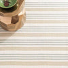 Olive Branch Woven Cotton Rug styled under a wood table. Styled view. 