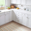 Olive Branch Woven Cotton Rug styled in a white kitchen. Styled view. 