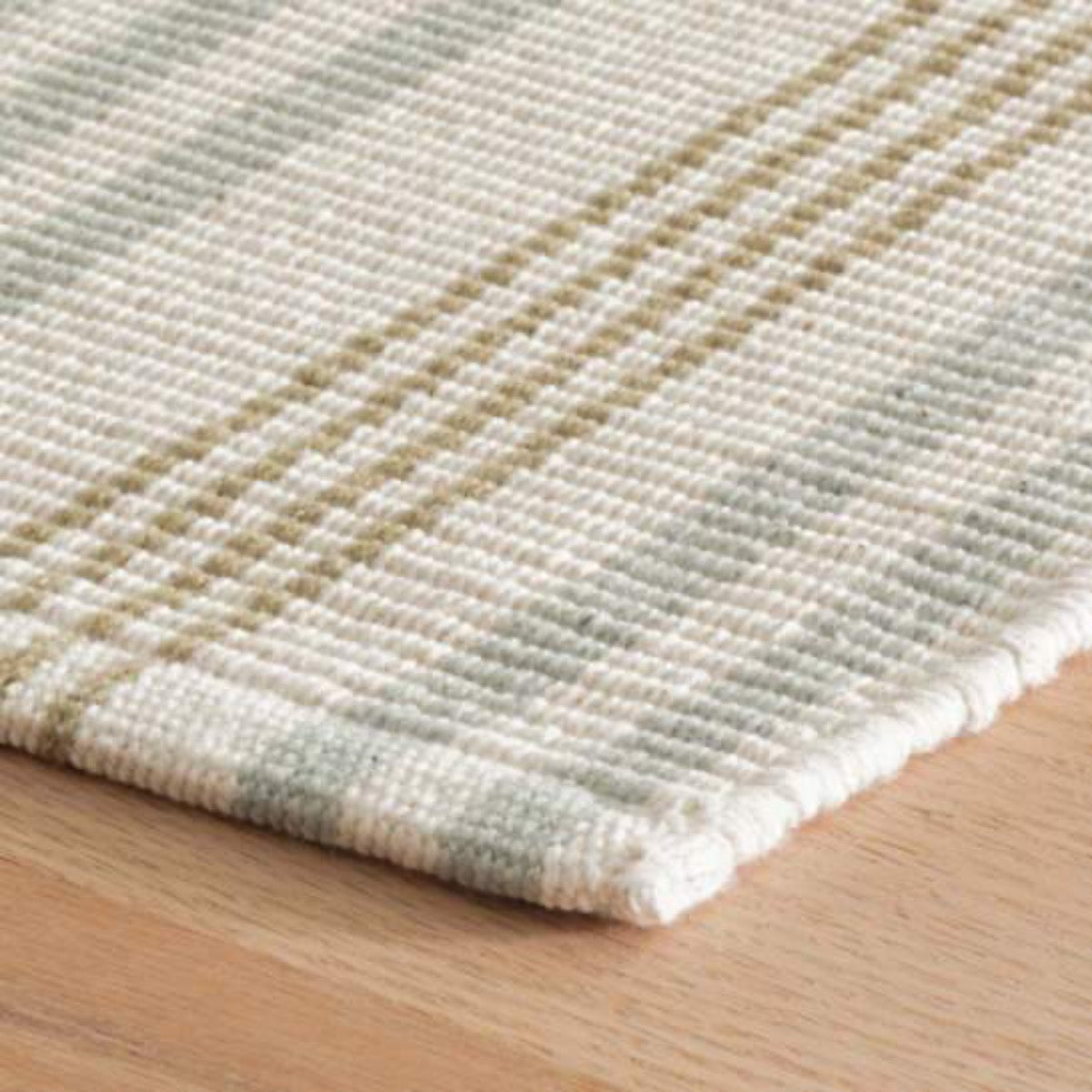 Olive Branch Woven Cotton Rug corner detail. Close-up corner view. 