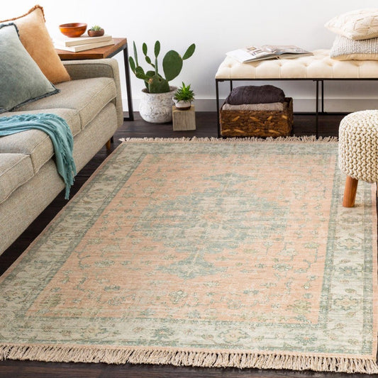 Palmer Rug styled in a living room with grey sofa and neutral stool. Styled view.