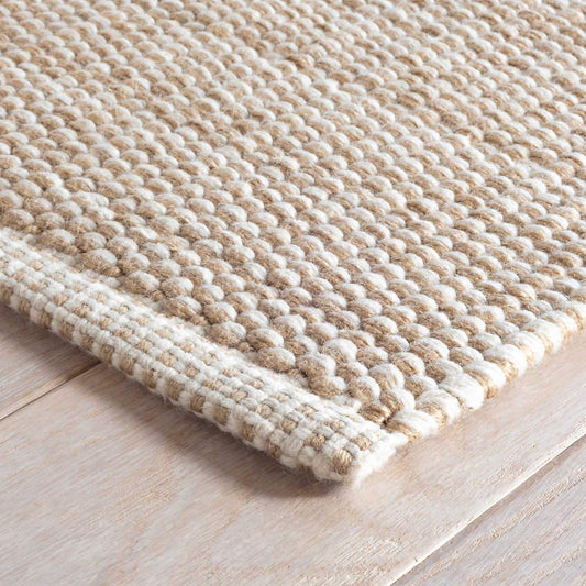 Pebble Natural Indoor/Outdoor Rug corner detail. Close-up corner view. 