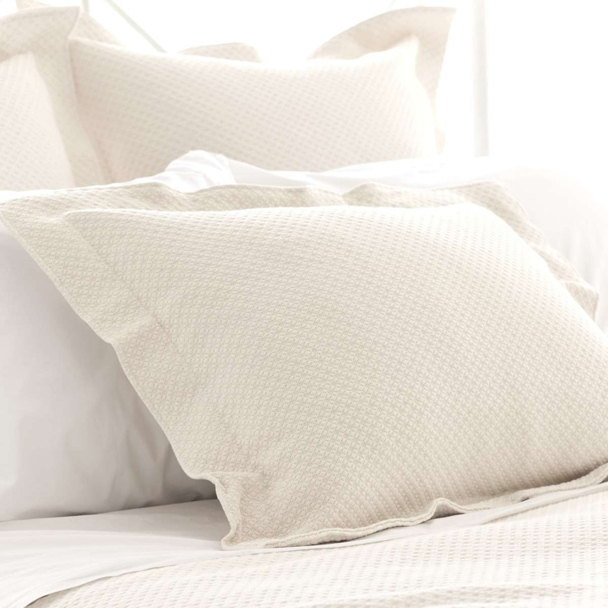 Petite Trellis Ivory Matelasse sham styled with neutral bedding. Styled view. 