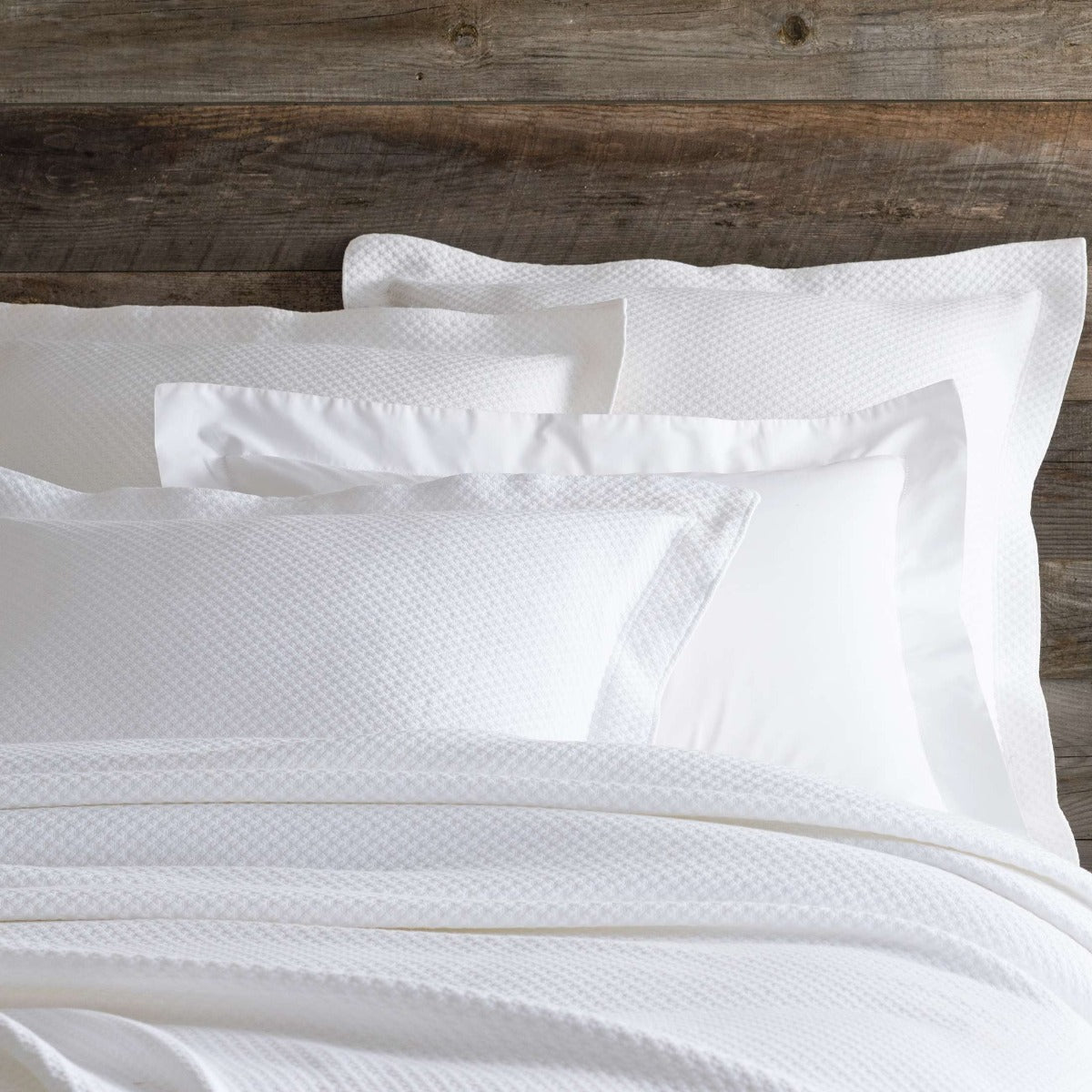 Petite Trellis White Matelasse sham styled with white bedding. Styled view. 