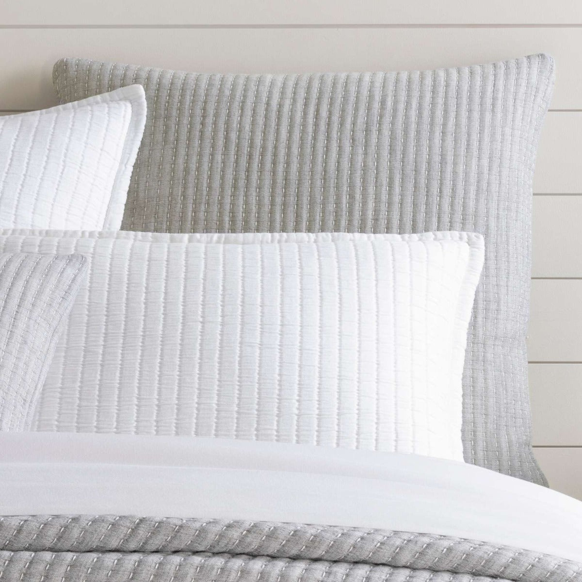 Pick Stitch Grey Matelasse Sham styled with white bedding. Styled view.