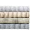 Pick Stitch Natural Matelasse Coverlet folded. Styled view. 