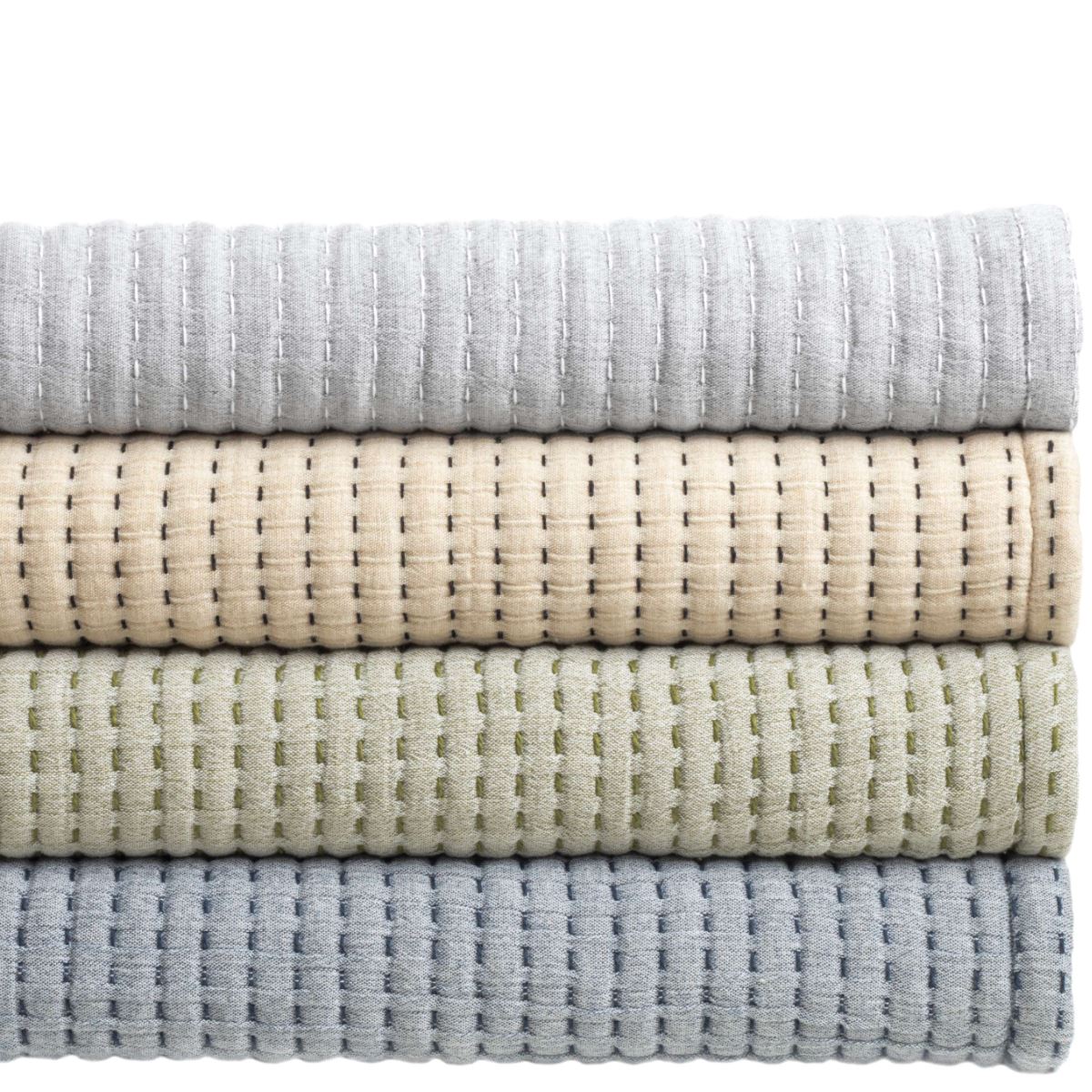 Pick Stitch Natural Matelasse Coverlet folded. Styled view. 