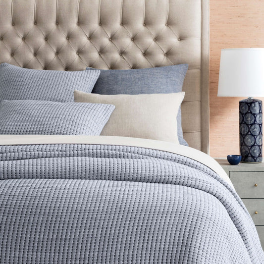 Pick Stitch Navy Matelasse Coverlet styled with neutral bedding. Styled view. 