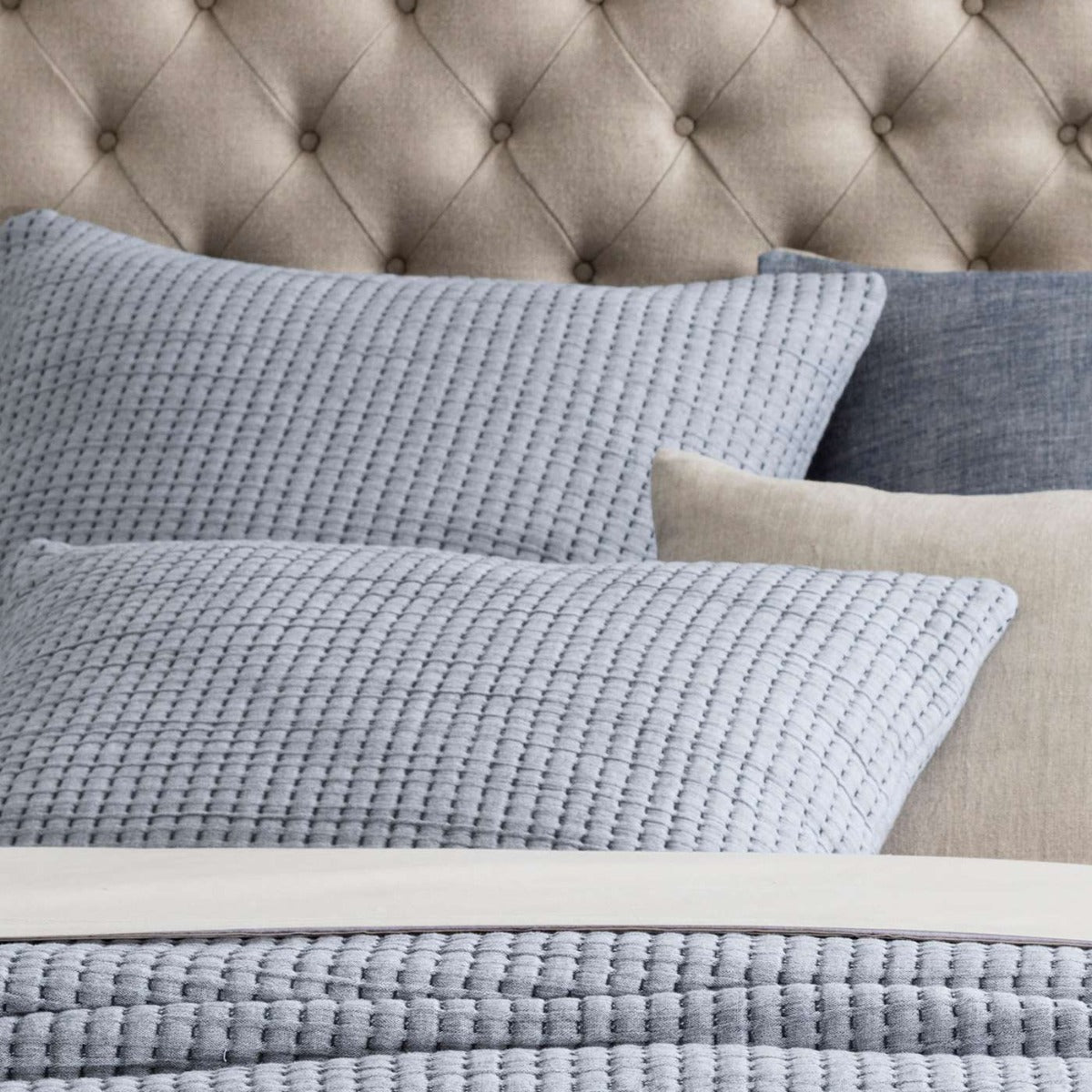 Pick Stitch Navy Matelasse Sham styled with neutral bedding. Styled view. 