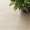Pixel Wheat Woven Sisal/Wool Rug styled under a plant. Styled view. 