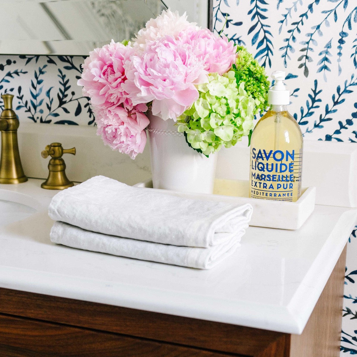 Rectangle Marble Tray - Medium styled with florals and soap in a bathroom. Styled view. 