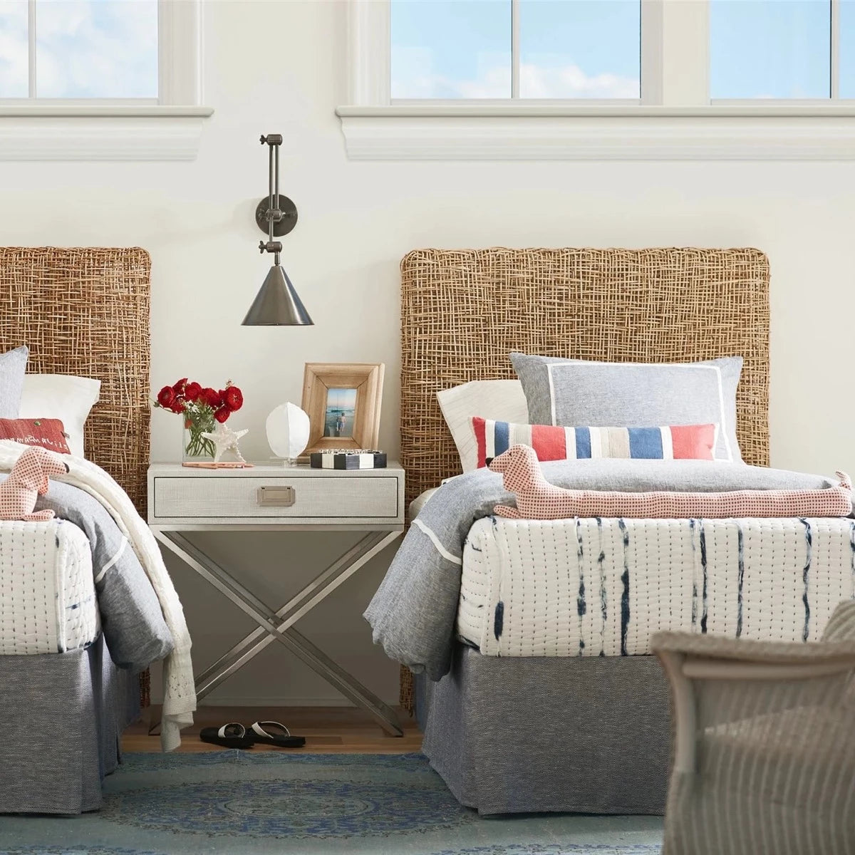Riviera Twin Headboard styled in a bedrooms beside night stand and metal wall sconce. Styled view.