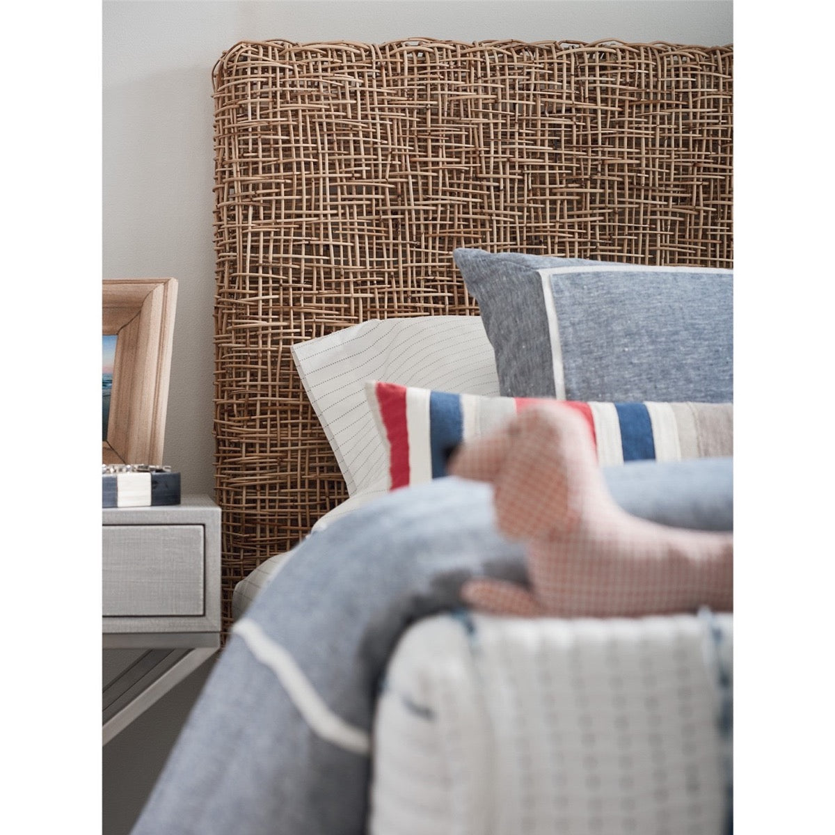 Riviera Twin Headboard styled with blue and red bed linens. Styled view.