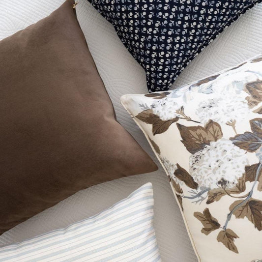 Royal Velvet Pillow - Cocoa styled with brown and navy pillows. Styled view. 