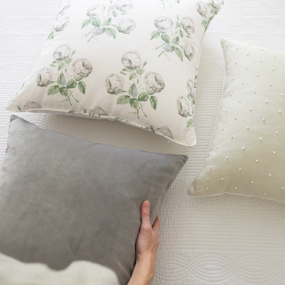 Royal Velvet Pillow - Dove Grey styled with white floral pillows. Styled view. 
