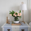 Bimini Buffet Lamp styled on a blue and white side table with greenery. Styled view.