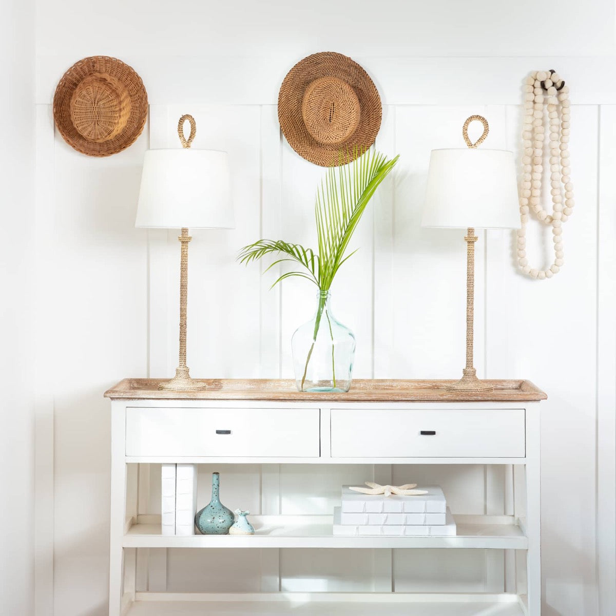 Bimini Buffet Lamp styled on a console table with decor and greenery. Styled view.
