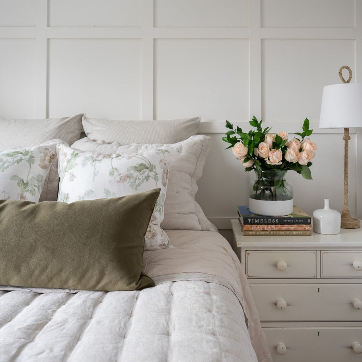 Bimini Buffet Lamp styled on a white side table in a bedroom. Styled view.