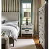 Sam End Table styled beside a grey bed with lamp, picture frames and decor. Styled view.