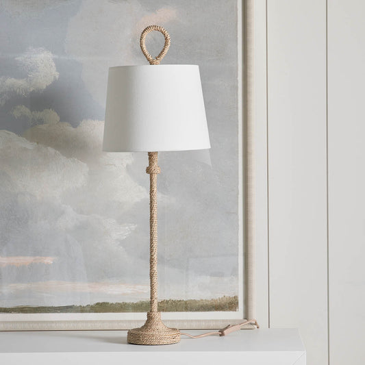 Bimini Buffet Lamp styled on a white surface with artwork. Styled view.