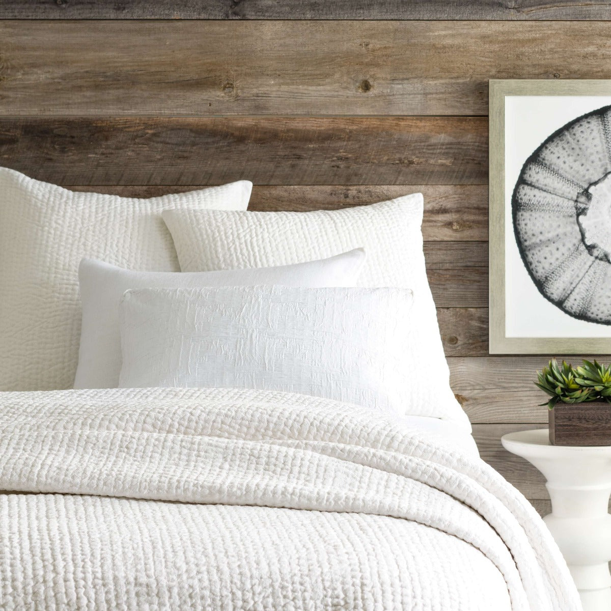 Seychelles Dove White Quilt styled with white sheets. Styled view. 