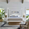 Sira Rattan Bench styled at the end of a bed with coastal furniture with blue accents. Styled view.