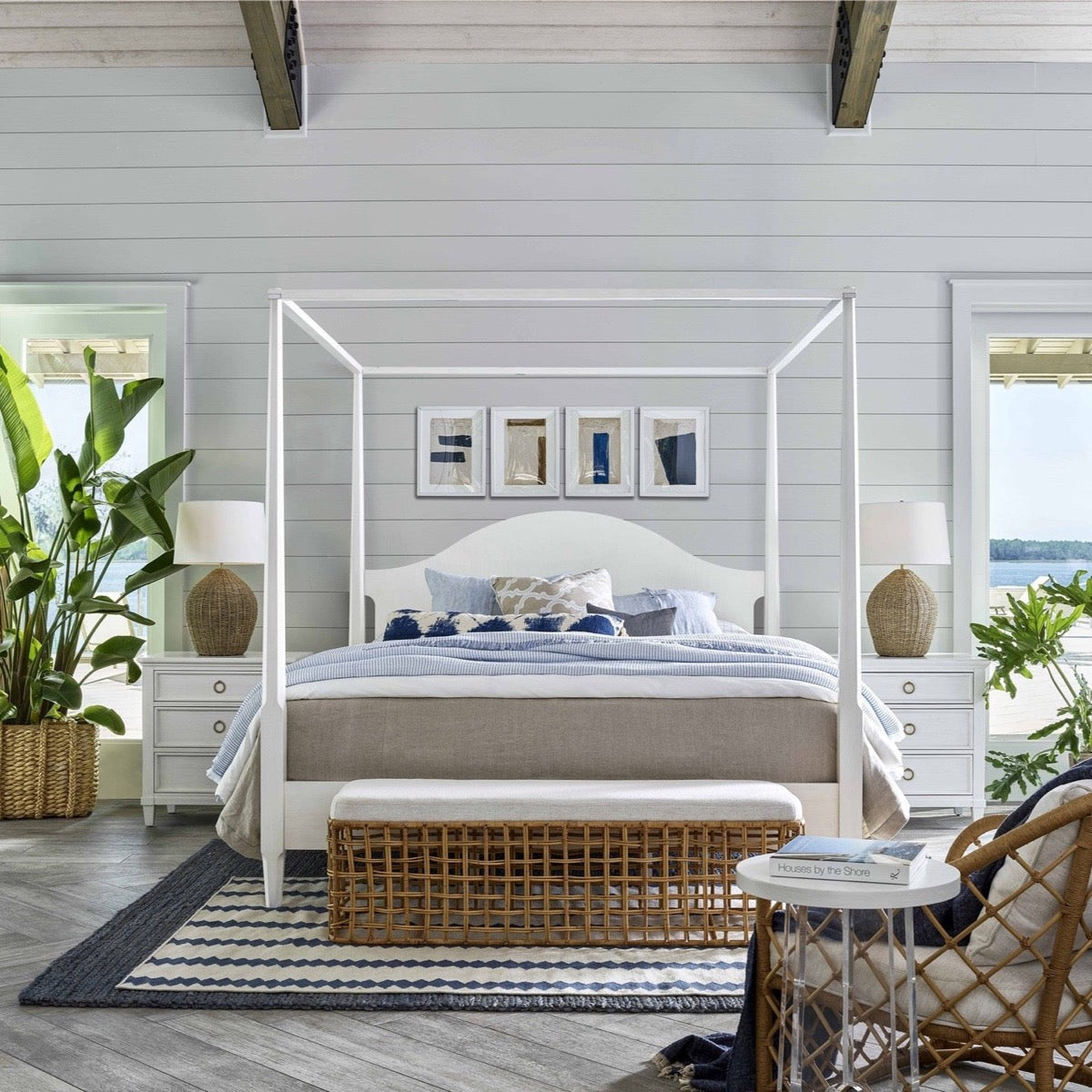 Sira Rattan Bench styled at the end of a bed with coastal furniture with blue accents. Styled view.