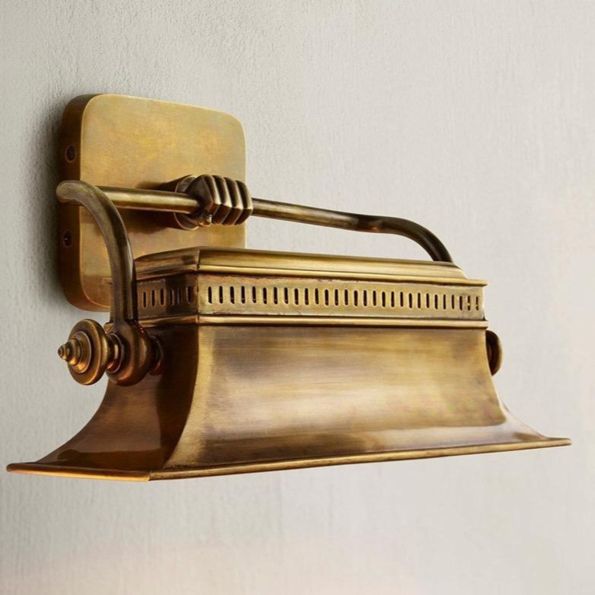 Sydenham Wall Sconce styled on a grey wall. Styled view.