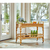 Tanner Rattan Bar Cart styled with drinks in front of a coastal view. Styled view.