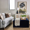 Thomas Block Ottoman styled with a blue sofa, jute rug and spring decor. Styled view. 