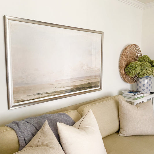 Tidal Beach styled above a neutral sofa. Styled view.