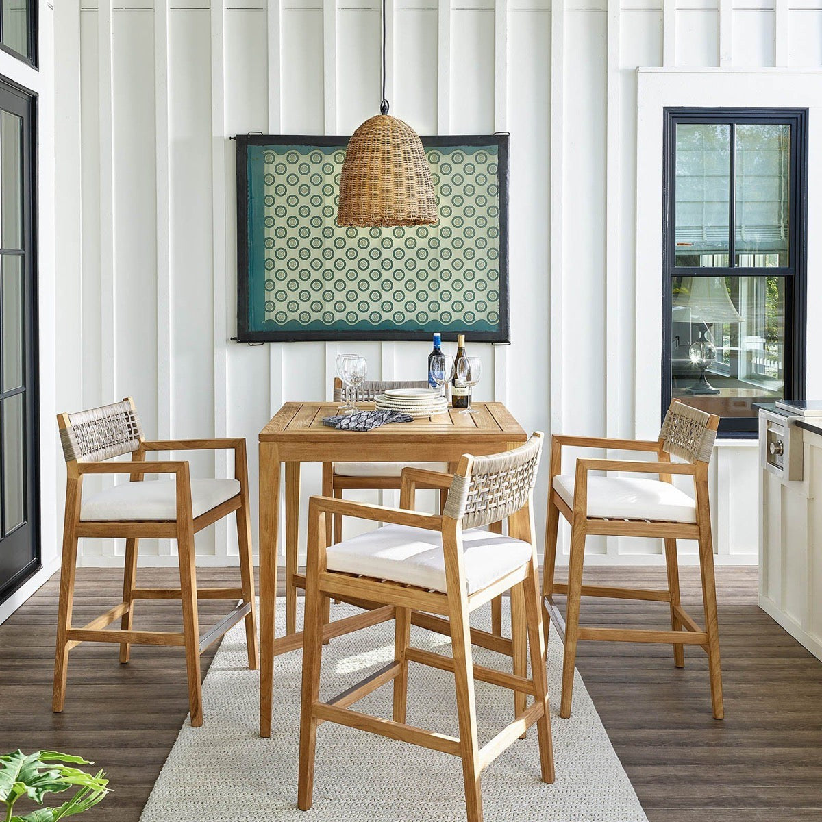 Beehive Outdoor Pendant - Small styled above a neutral dining set. Styled view.