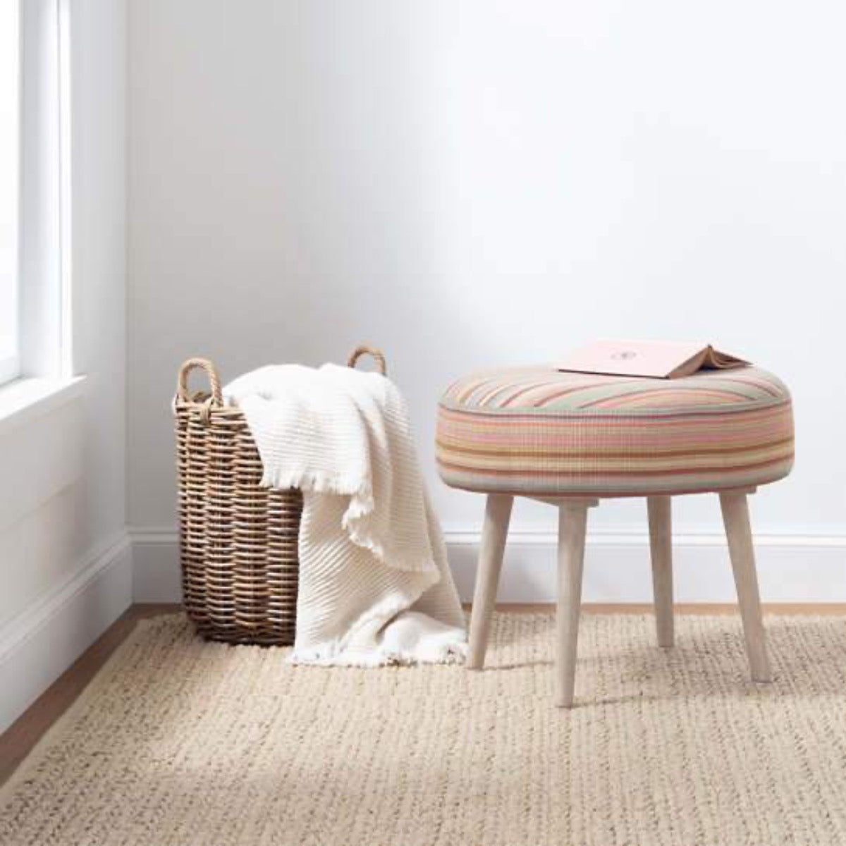 Veranda Natural Indoor/Outdoor Rug styled under baskets and stool. Styled view. 