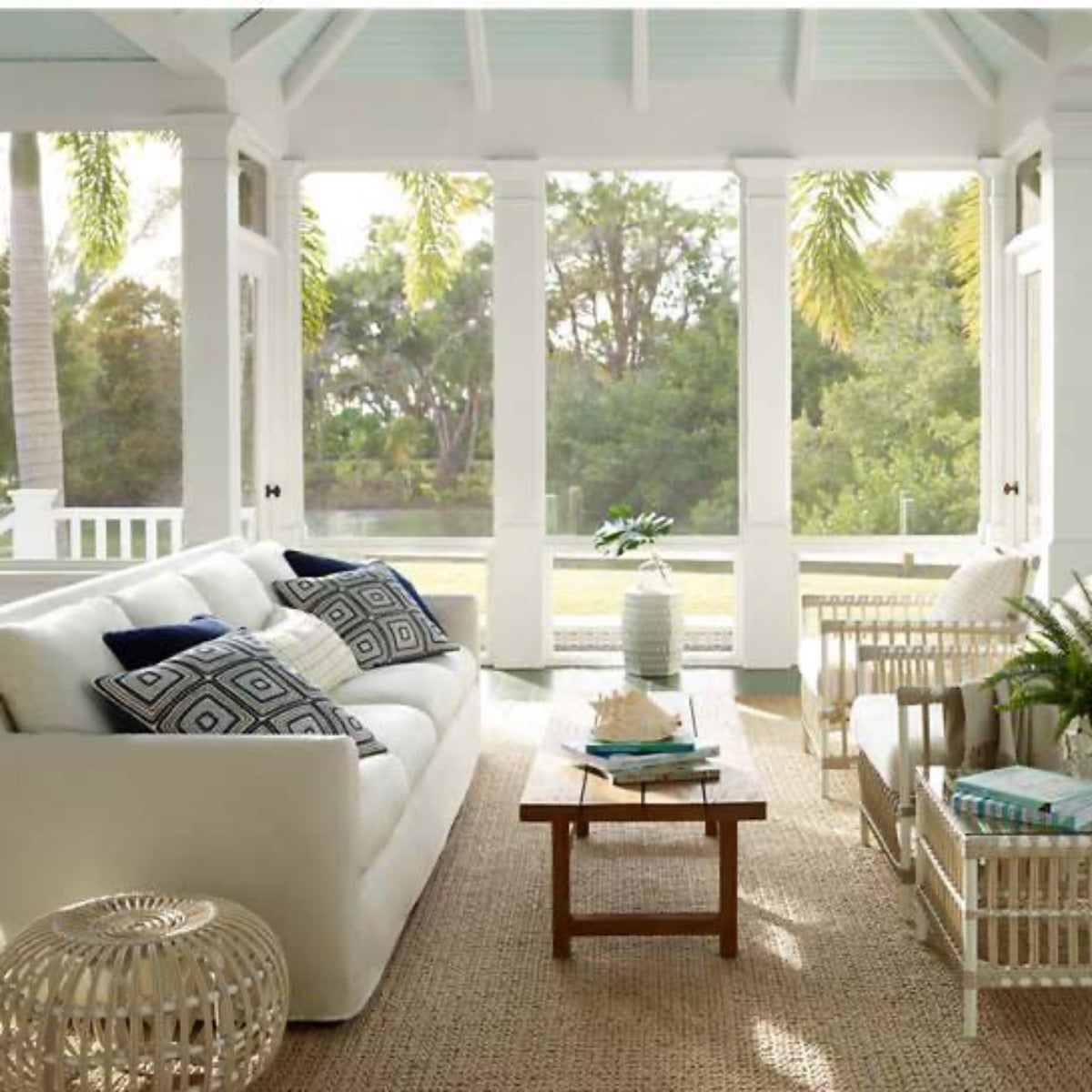 Veranda Natural Indoor/Outdoor Rug styled in a neural sunroom. Styled view. 