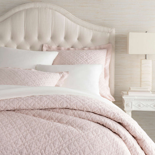 Washed Linen Slipper Pink Quilt styled with white sheets. Styled view. 