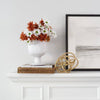 Wilmot Rattan Tray styled with florals and decor on a white mantel. Styled view.