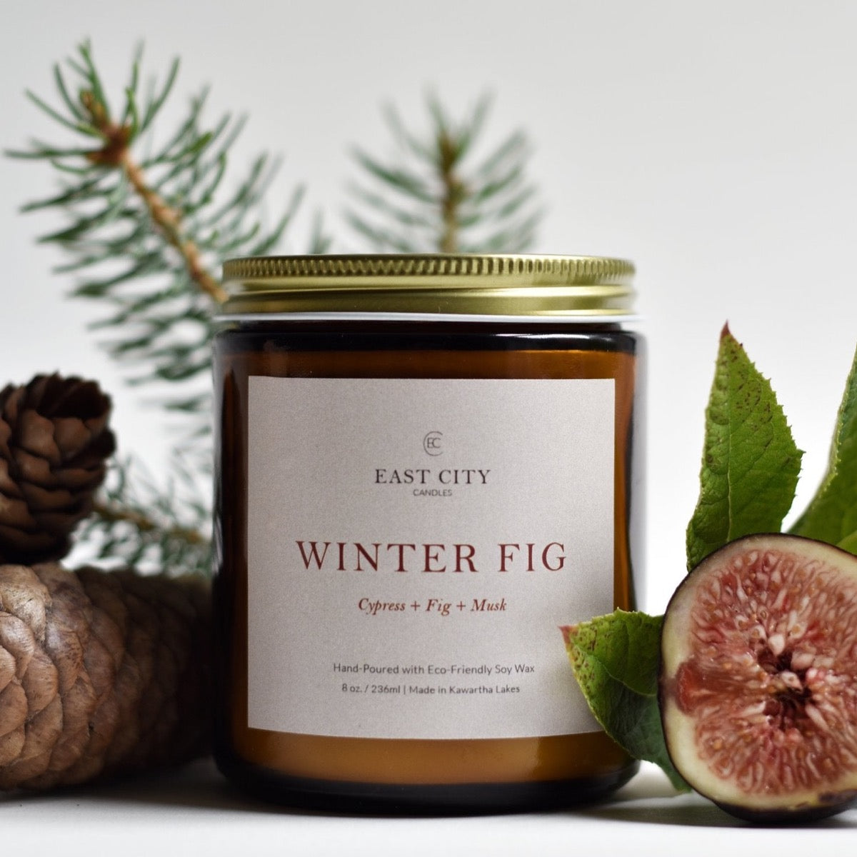 Winter Fig Candle styled with figs and pine. Styled view.